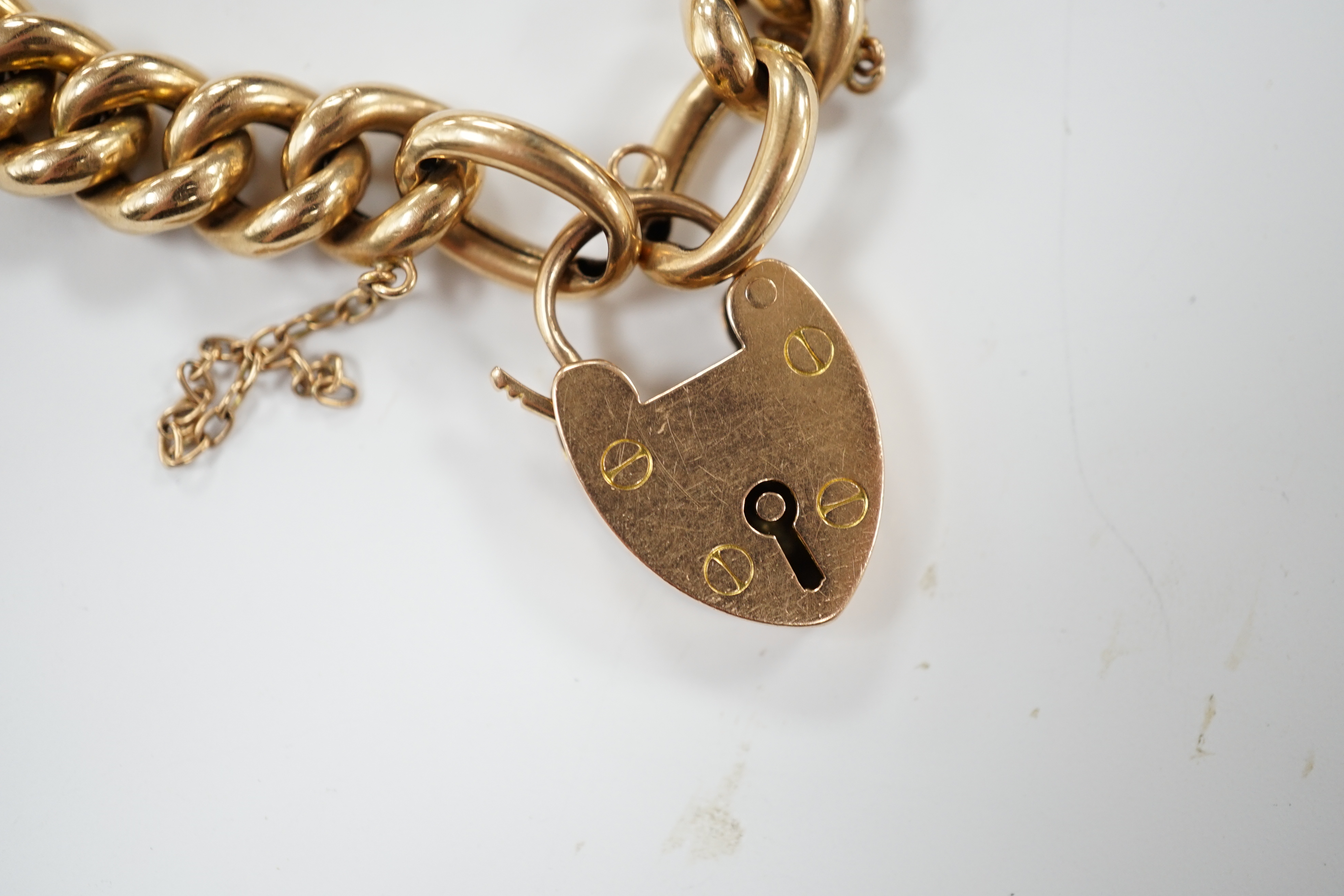 An Edwardian 15ct curb link bracelet, with heart shaped padlock clasp, 18cm